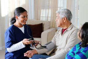 caregiver taking blood pressure